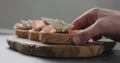 Slow motion man hand take bruschetta with pancetta, ricotta and fig marmalade Royalty Free Stock Photo