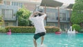 Slow motion,man jumps into the pool and takes a fun vacation inside a hotel