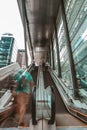 Slow motion of man walking up escalators in city Royalty Free Stock Photo