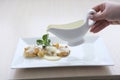 Slow motion of pouring syrup on stack of pancakes with butter. Tasty breakfast food