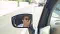 SLOW MOTION: Reflection of an angry driver in the side mirror of his new car. Royalty Free Stock Photo