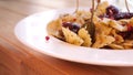 Farfalle pasta with sun-dried tomatoes and capers decorated with rosemary 4K slowmo close-up camera motion