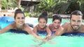 Slow Motion Shot Of Family On Airbed In Swimming Pool