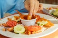 Slow Motion Shrimp dunked in red salsa mexican seafood delicious Royalty Free Stock Photo