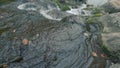 Slow Motion of A Small Waterfall With Mossy Rocks