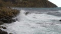 Slow motion of smashed drops from waves that hit the stone shore Cerulean water hills straith to coast