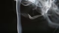 SLOW MOTION: Smoke lifts and dispels on a black background