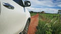 SUV car in movement on a dirt road of the countryside