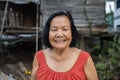 Slow-motion of Thai elderly woman in round-necked sleeveless collar laughing in wooden home Royalty Free Stock Photo
