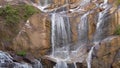 Slow motion tilt up video of waterfall in tropical jungle