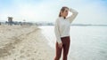 Slow motion of tired young woman taking a break while running on the sandy sea beach. Concept of healthy lifestyle, fitness and Royalty Free Stock Photo