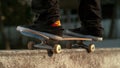 SLOW MOTION: Unrecognizable man skateboarding in the outdoor park grinds a ledge