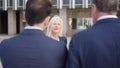 Angry businesswoman scolding her employees in the street