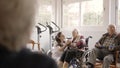 Physiotherapists talking to senior people while exercising in geriatrics