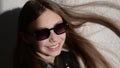 Slow motion video of a stylish child in leather jacke with glasses