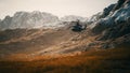 Slow motion Vietnam War era helicopter in mountains