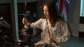 Slow motion. A young girl musician concentrates on playing a composition on an electronic drum kit while sitting in the