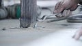 Slow-motioned closeup of the dirty hand of a worker tightening a bolt with wrench