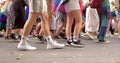 Slow movement of people on foot. Legs of crowd people during the