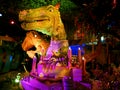 Funny Dino world family ride indoors through garden