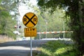 Slow Rough Railroad Crossing sign with railroad crossing in back Royalty Free Stock Photo