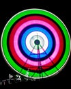 Slow shutter image of a rotating Giant Colorful Ferris wheel spinning at night in funfair Royalty Free Stock Photo