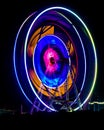 Slow shutter image of a rotating Giant Colorful Ferris wheel spinning at night in funfair Royalty Free Stock Photo