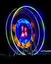 Slow shutter image of a rotating Giant Colorful Ferris wheel spinning at night in funfair Royalty Free Stock Photo