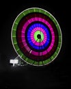 Slow shutter image of a rotating Giant Colorful Ferris wheel spinning at night in funfair. Royalty Free Stock Photo