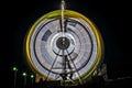 Slow shutter, night image of a spinning giant wheel in funfair. Royalty Free Stock Photo