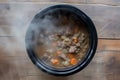 slowcooker with beef stew simmering, top view steam visible