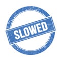 SLOWED text on blue grungy round stamp Royalty Free Stock Photo