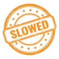 SLOWED text on orange grungy vintage round stamp