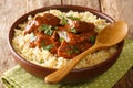 Slowly braised pork in red wine served with bulgur close-up in a bowl. horizontal