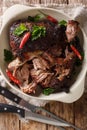 Slowly cooked shredded pulled pork close-up on a plate. Vertical top view Royalty Free Stock Photo