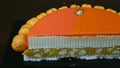Slowly panorama right on half of orange glazed cheesecake on almond interlayer