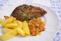 Slowly roasted spring lamb leg with rosemary and garlic served with sweet glazed onions, carrots, apples and baked potatoes Royalty Free Stock Photo