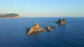 Slowmotion aerial video. The Sveta Nedelja - Christian church on a tiny island in the sea close to the city of Petrovac