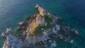 Slowmotion aerial video. The Sveta Nedelja - Christian church on a tiny island in the sea close to the city of Petrovac