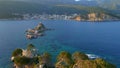 Slowmotion aerial video. The Sveta Nedelja - Christian church on a tiny island in the sea close to the city of Petrovac