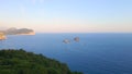 Slowmotion aerial video. The Sveta Nedelja - Christian church on a tiny island in the sea close to the city of Petrovac