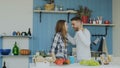 Slowmotion of Cheerful and attractive young couple in love dancing together rocknroll dance in the kitchen at home on