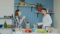 Slowmotion of Cheerful and attractive young couple in love dancing together rocknroll dance in the kitchen at home on