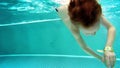 Slowmotion: Playfull boy dives in hot winter pool