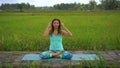 Slowmotion steadicam shot of a young woman doing meditation for Muladhara chakra in a Balinese way