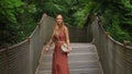 Slowmotion video. Woman tourist is walkimg on rope bridge in Yildiz Park. Besiktas, Istanbul, Turkey. Turkiye