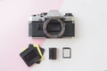 SLR Camera with 35 mm Negative Film, Slides and Memory Card on Pink Back Royalty Free Stock Photo