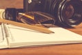 SLR camera on the table next to negative film strip and pencil Royalty Free Stock Photo