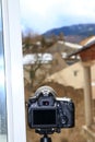 SLR camera on a tripod taking pictures of french village Royalty Free Stock Photo