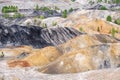 Sludge pit with hills and orange soil, contaminated land with industrial waste Royalty Free Stock Photo